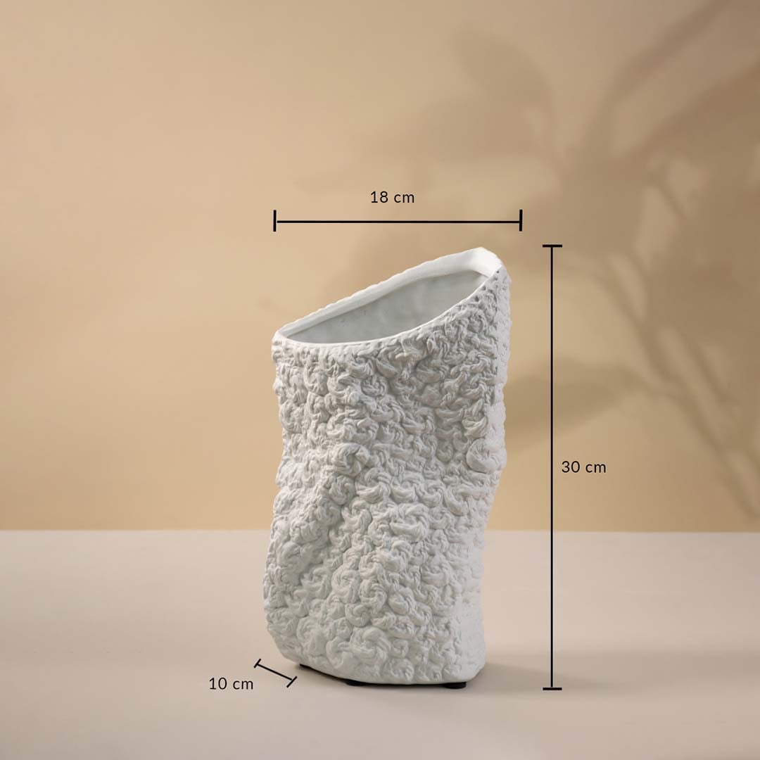 Small round black textured ceramic vase measuring 12 cm in height and 11.5 cm in width displayed on beige background.