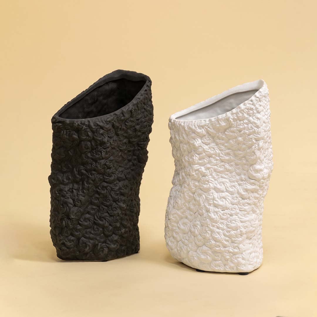 Set of round black and white textured ceramic vases arranged together for elegant contemporary home styling.