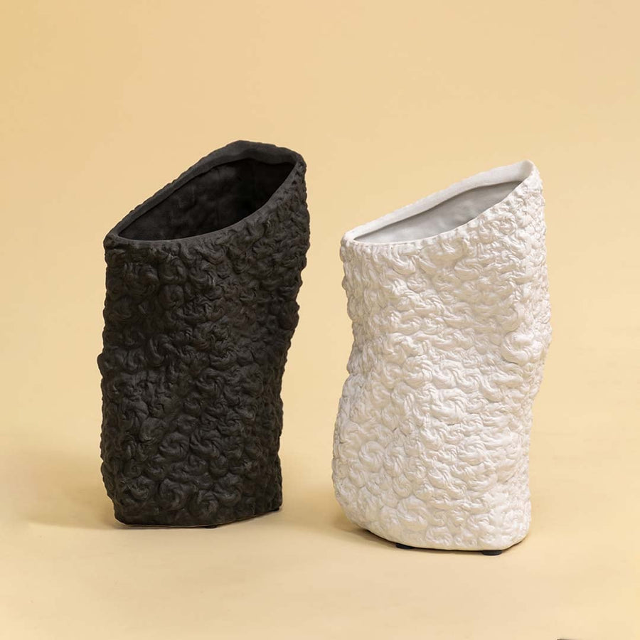 Set of round black and white textured ceramic vases arranged together for elegant contemporary home styling.
