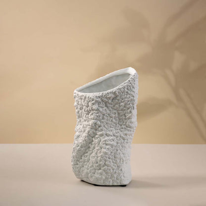 White ceramic decorative vase with organic sculptural form and textured finish for elegant modern home decor styling.