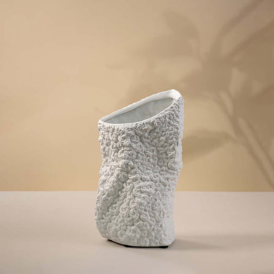 White ceramic decorative vase with organic sculptural form and textured finish for elegant modern home decor styling.