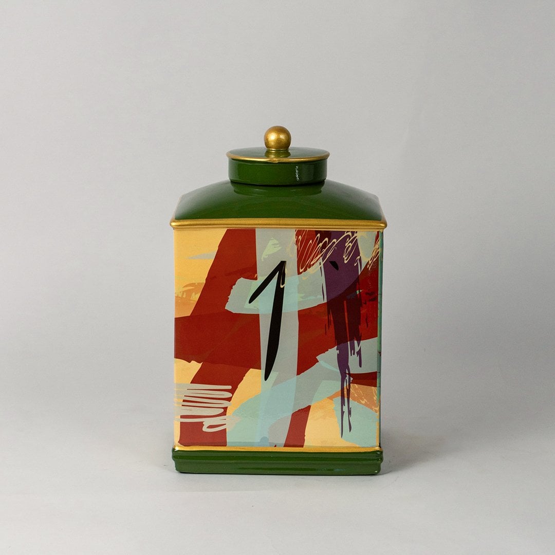 Abstract design jar with green lid and golden knob shown clearly on white background with vibrant detailing.