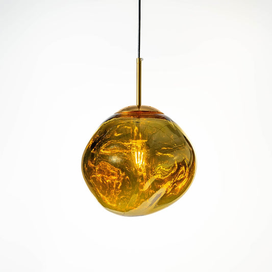 Gold glass pendant lamp illuminated beautifully through golden tinted glass creating a rich reflective glow on white background.
