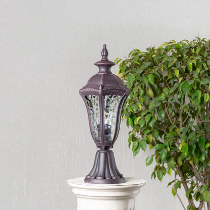 Antique brown pillar light with patterned clear glass displayed off on white background highlighting vintage classic style.