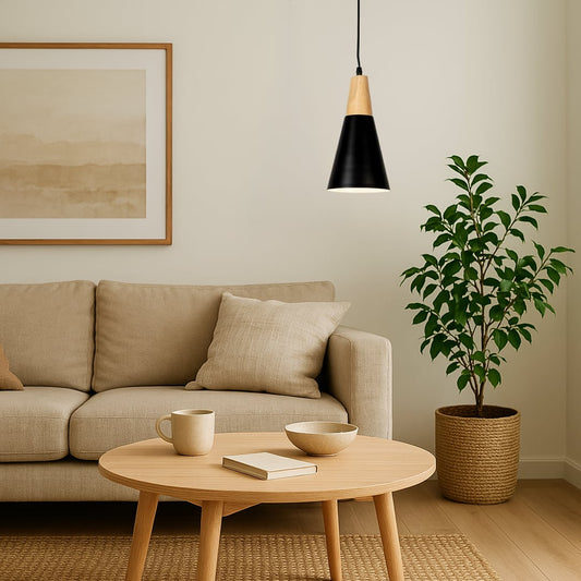 Black metal pendant light above coffee table adding Scandinavian elegance and warm ambient lighting to modern living rooms.