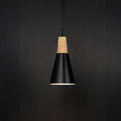 Black metal pendant light with wooden top and conical shade glowing on black background for modern home interiors.