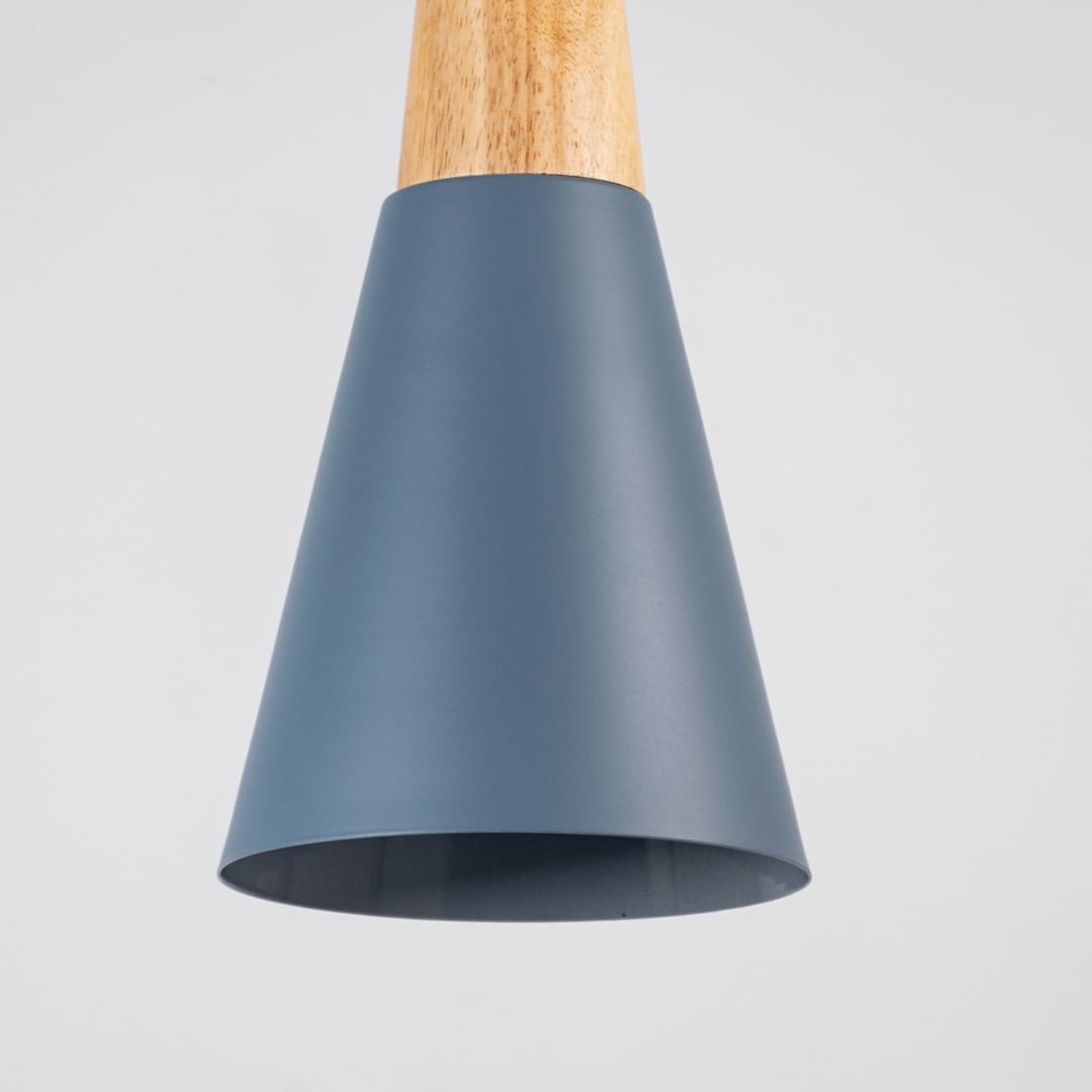 Closeup of pendant light with natural wood top and matte finish shade showing modern design details.