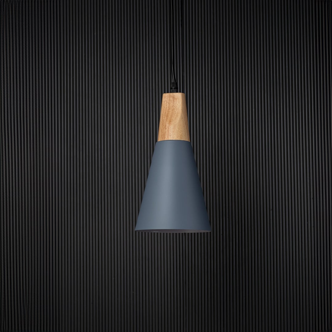 Pendant light with wooden top and matte shade displayed on black background for elegant lighting presentation.