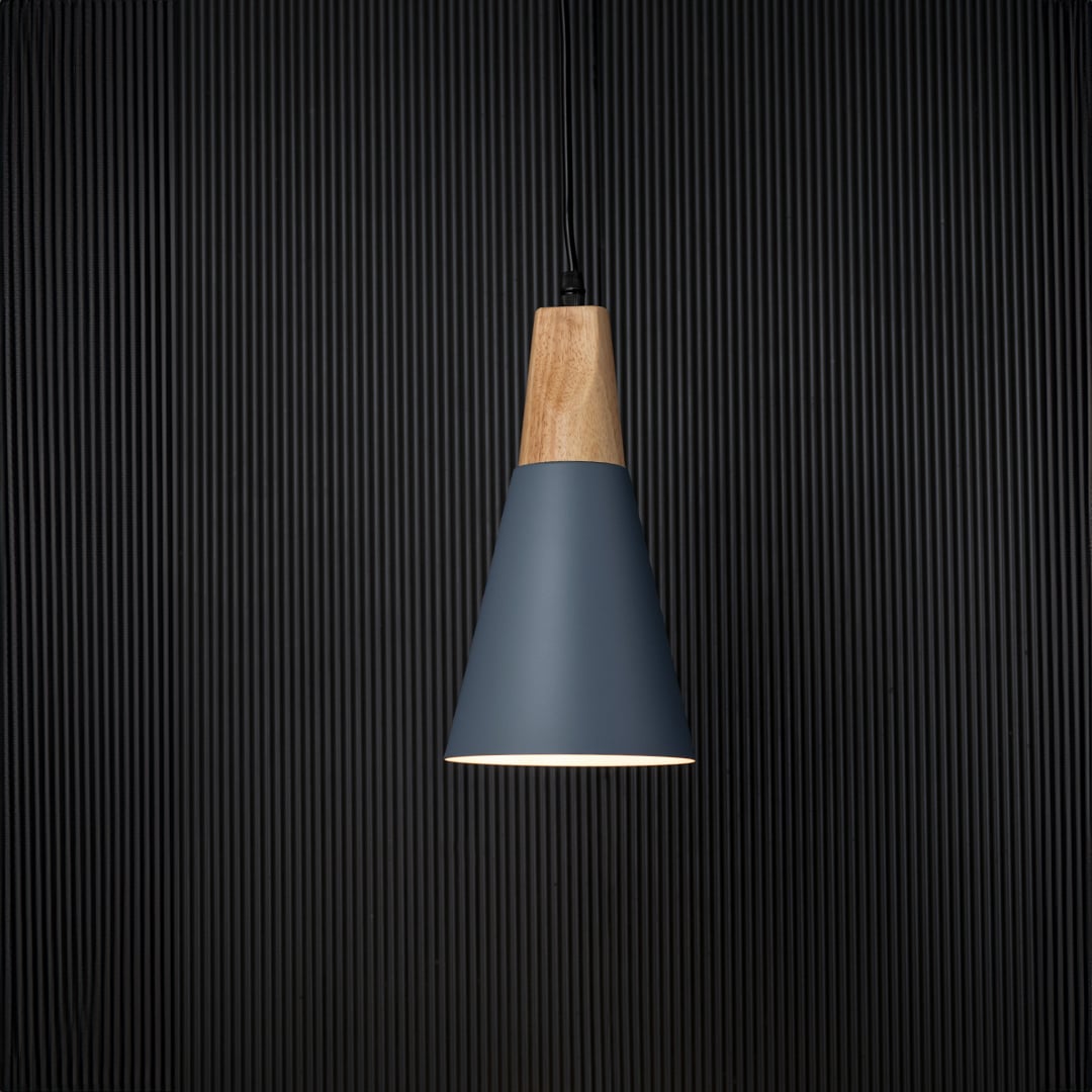 Pendant light with wooden top and matte shade displayed on black background for elegant lighting presentation.