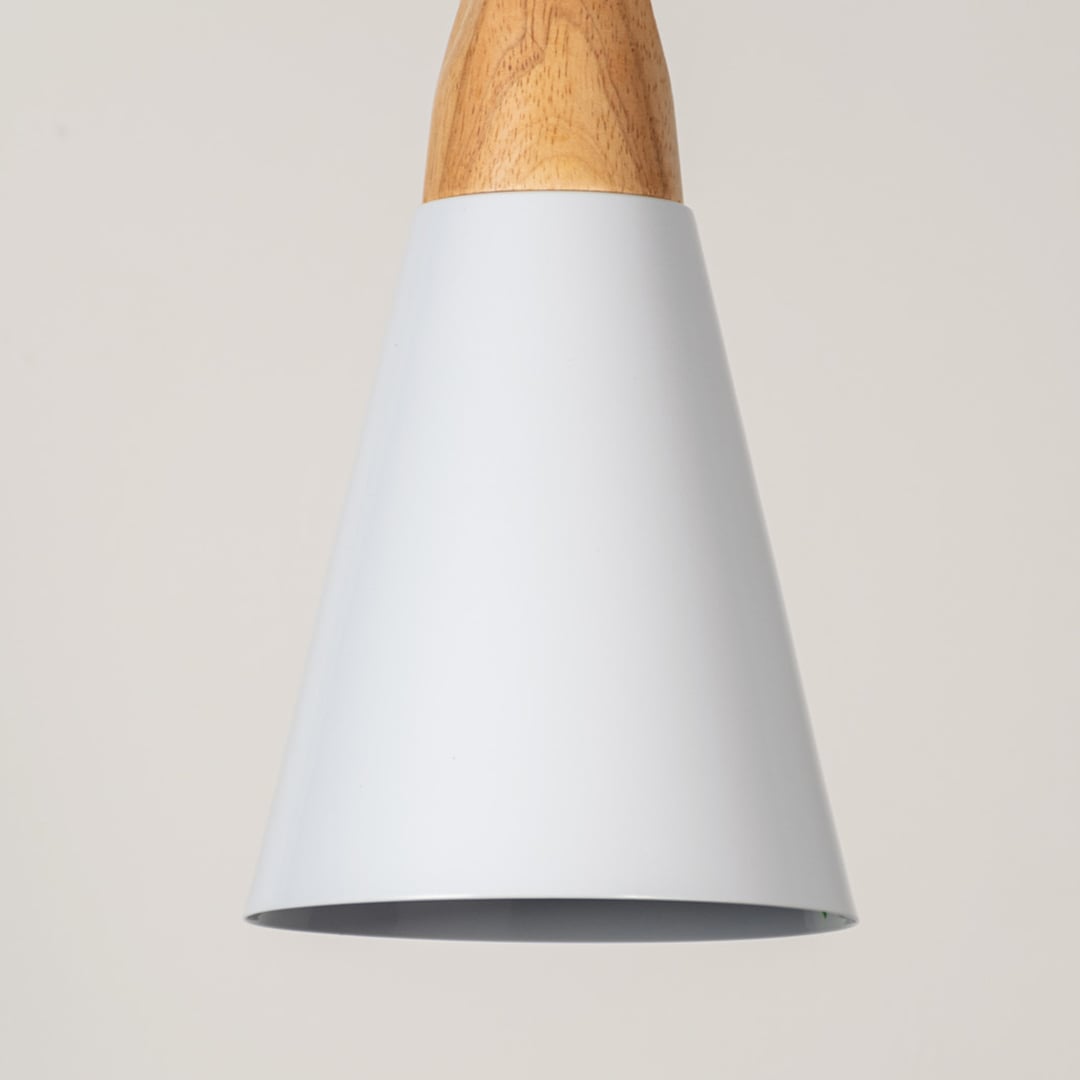 Closeup view of white cone pendant light with wood top is a modern minimalist ceiling fixture.