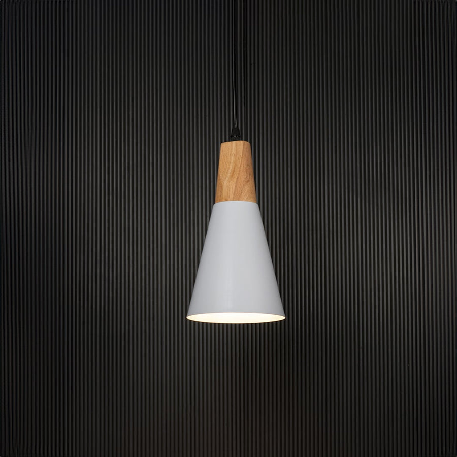 White cone pendant light with wooden finish turned on against black background is a stylish hanging lamp for kitchen island or dining area.