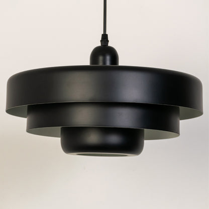 Closeup pendant light in black metal finish with layered shade design for kitchen or dining decor lighting white background.