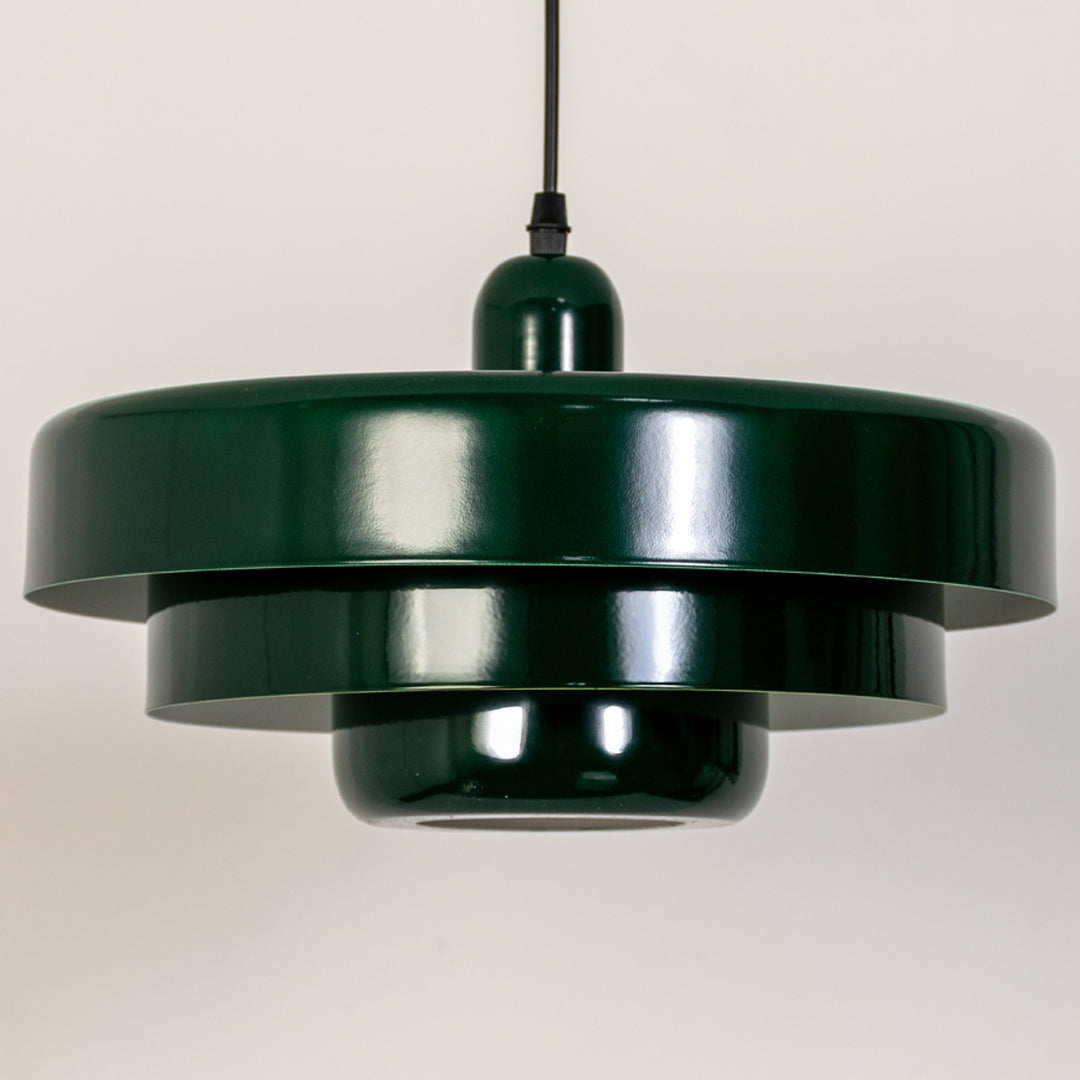 Closeup pendant light in green metal finish with layered shade for kitchen or dining decor lighting white background.