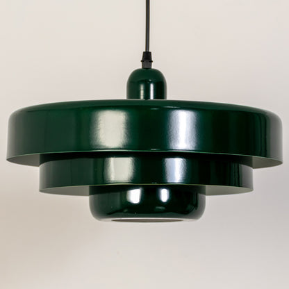 Closeup pendant light in green metal finish with layered shade for kitchen or dining decor lighting white background.