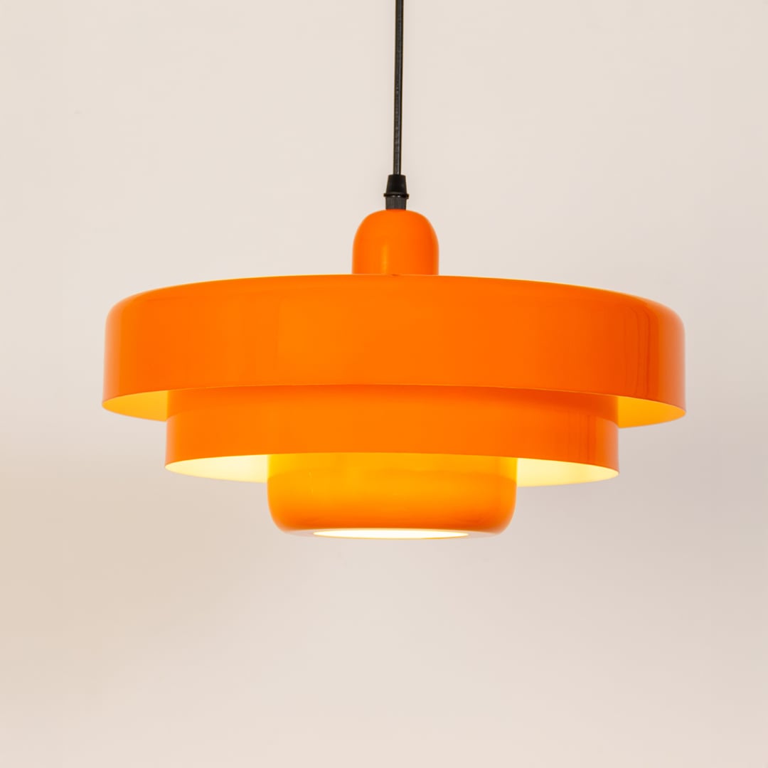 Orange metal pendant light with layered shade design for kitchen island dining room and modern ceiling lighting.