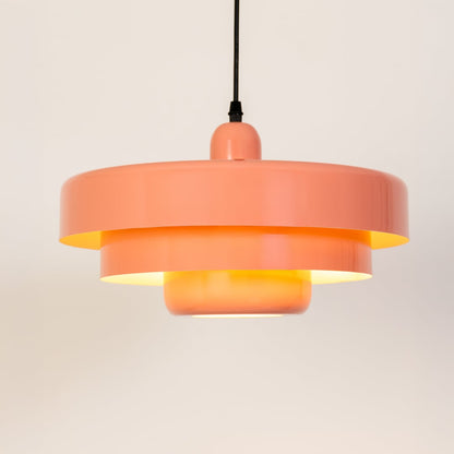 Modern peach metal pendant light glowing softly for kitchen and dining decor on a clean white background.