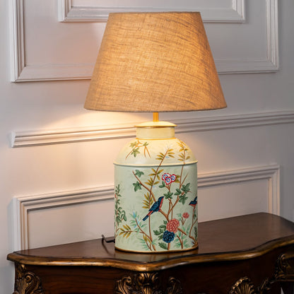 Tropical Garden green table lamp illuminated on white background showcasing leafy pattern vibrant glow and fresh interior decor mood.