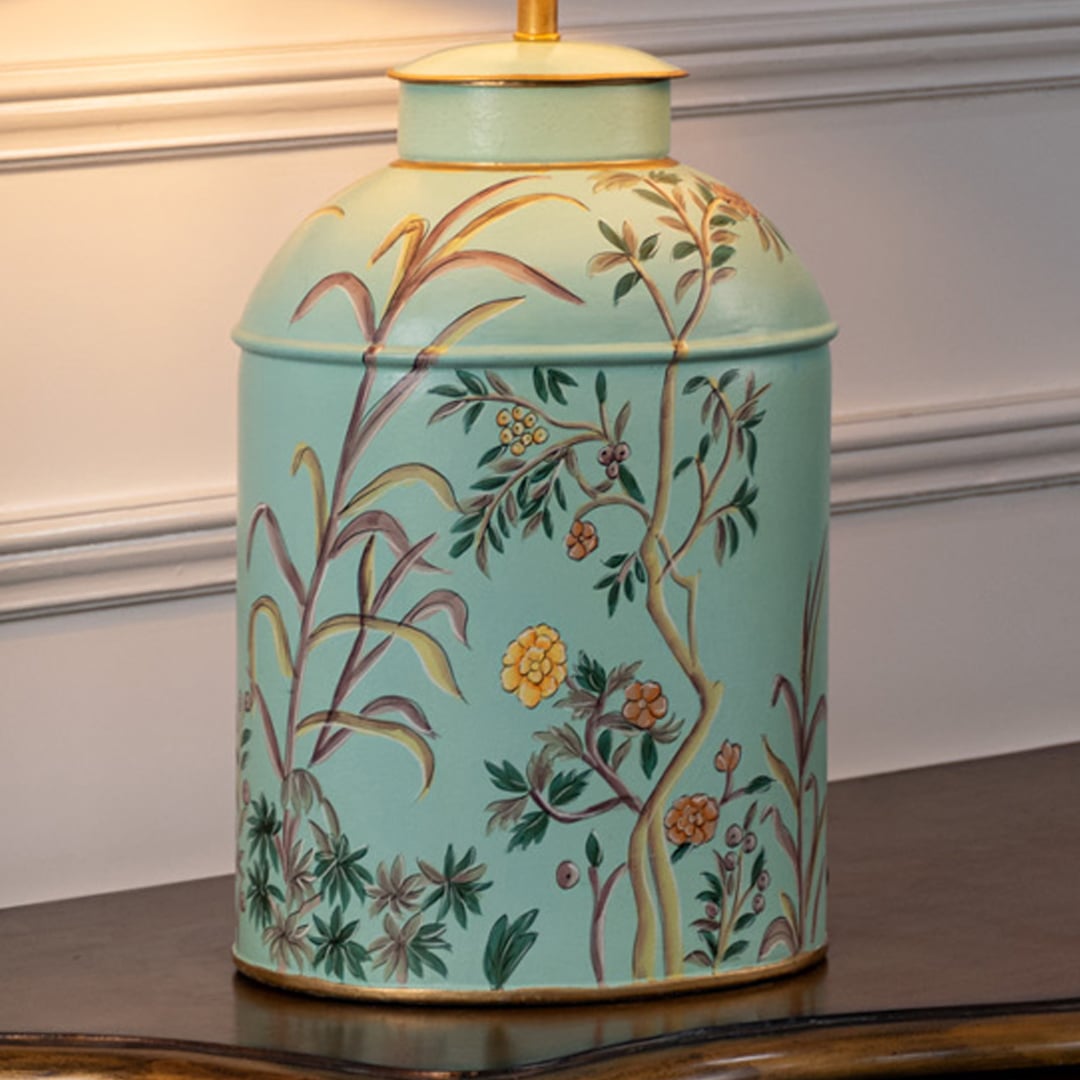 Table lamp closeup highlighting aqua ceramic base with delicate floral pattern and coordinated fabric shade.