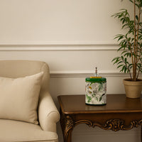 Green tropical decorative jar displayed on wooden side table adding elegance to cozy beige living room decor.