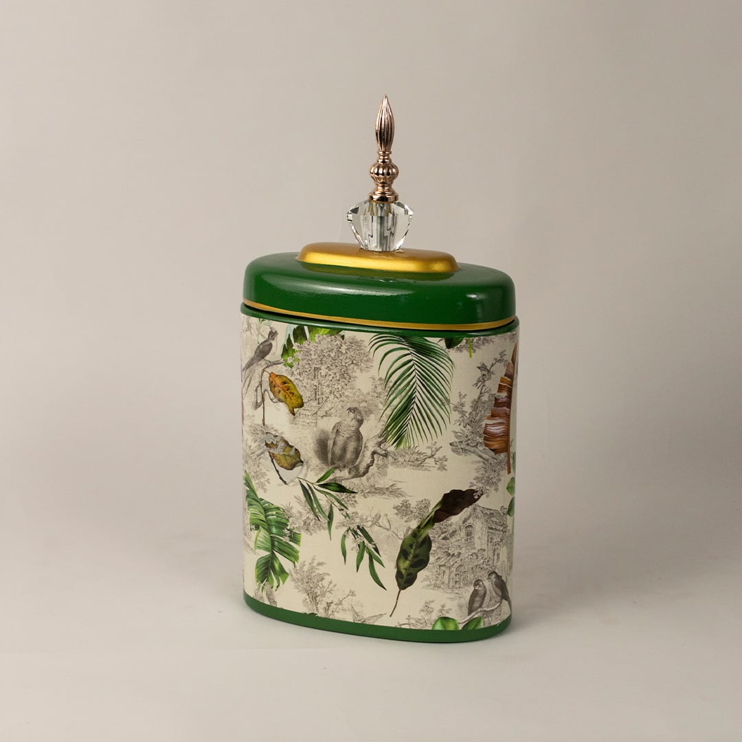 Side angle of green tropical decorative jar showing elegant silhouette  gold detailing  and detailed foliage pattern.