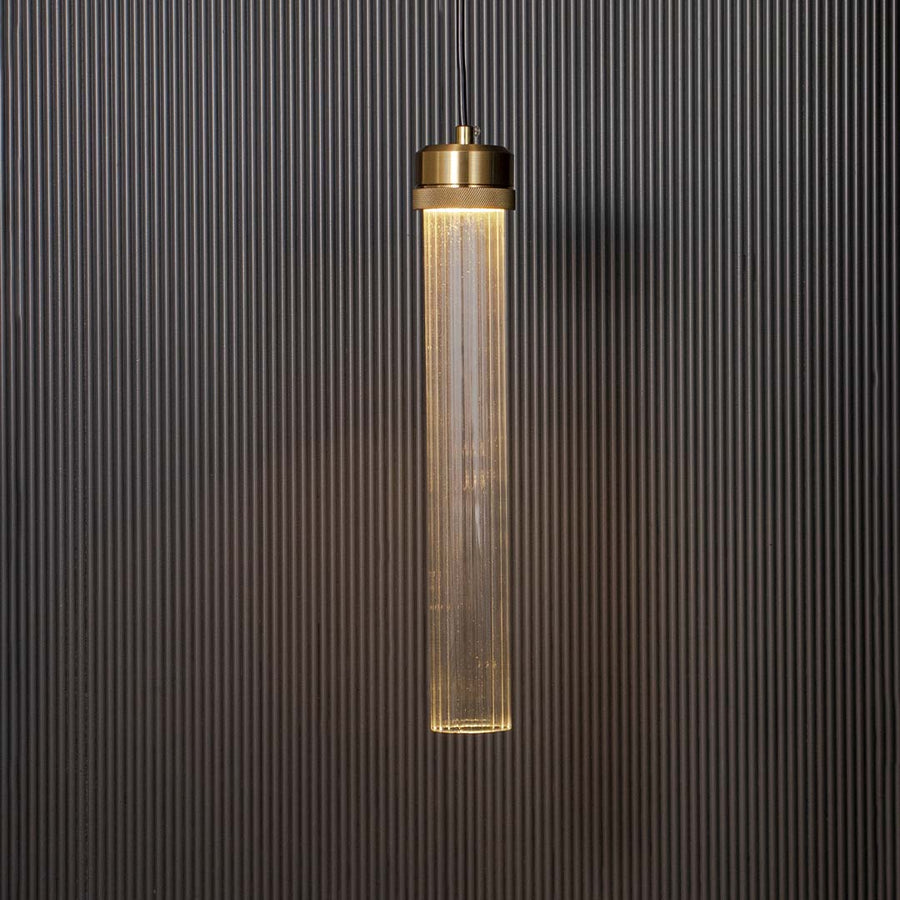 Tubular glass pendant lamp glowing with golden holder ribbed glass design elegant ceiling light for luxury modern home interiors.