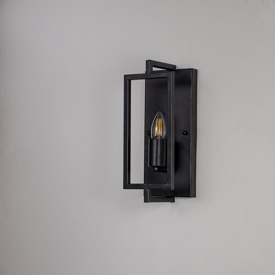 Wall light with black metal rectangular frame and exposed bulb design ideal for modern bedroom living room and hallway.