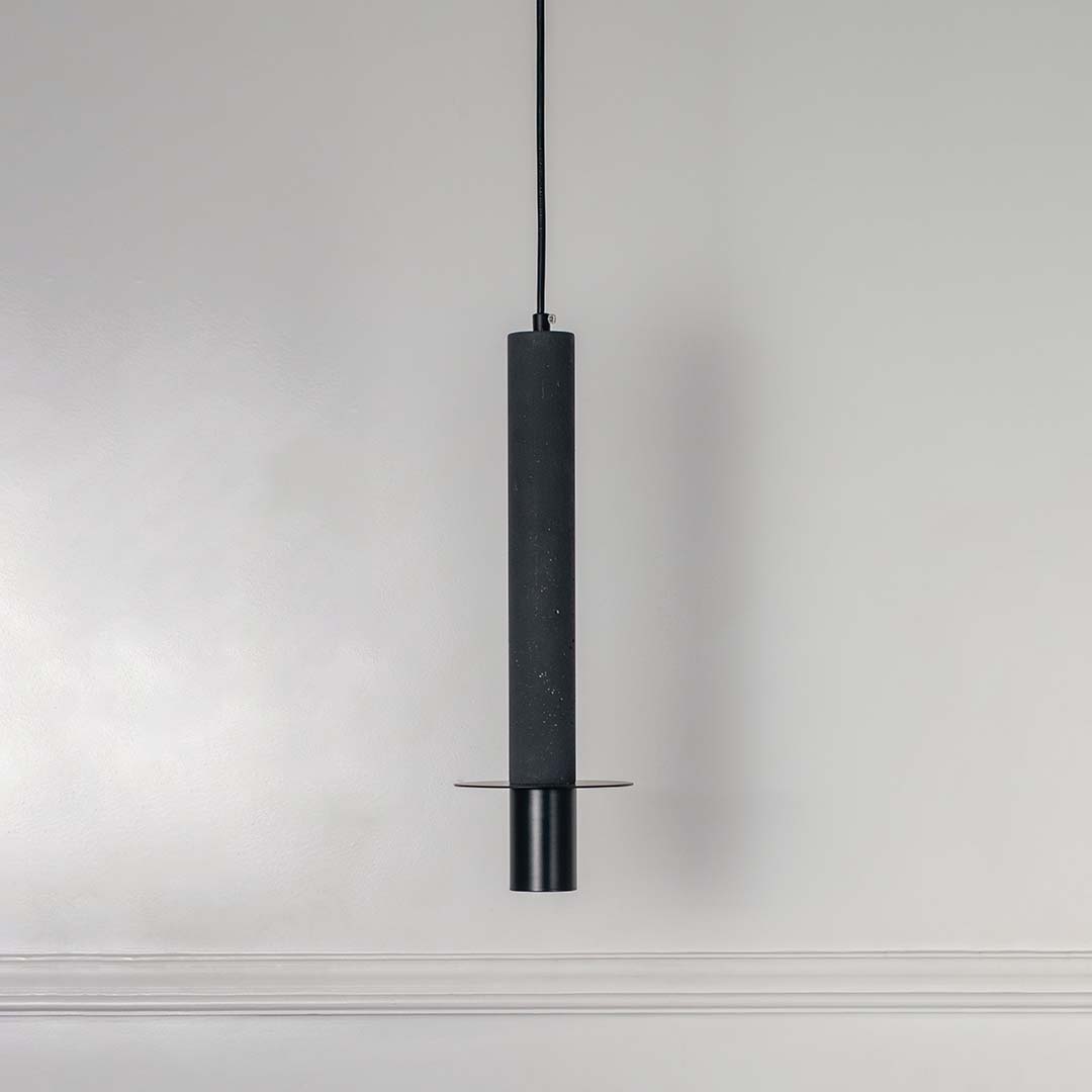 Black cylindrical metal pendant light with polished silver accents crafted for elegant interiors.