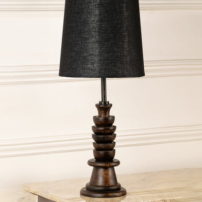 Turned wood lamp base with rich dark finish and bronze accents showcasing classic craftsmanship and decorative appeal.