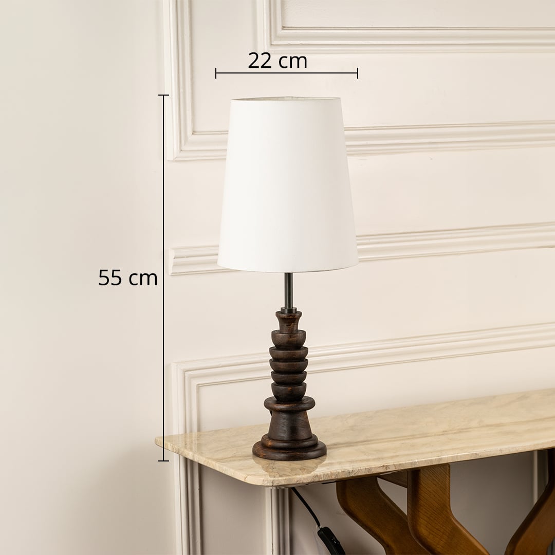 Table lamp shown with 55 cm height and 22 cm shade width featuring a carved dark wooden base and white shade ideal for modern interior home decor lighting.