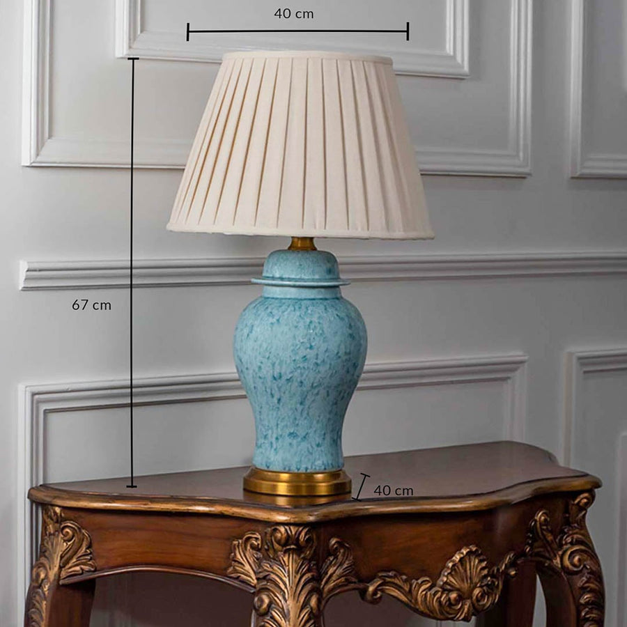 Blue ceramic table lamp with cream pleated shade and golden base showing 67 cm height and 40 cm width.