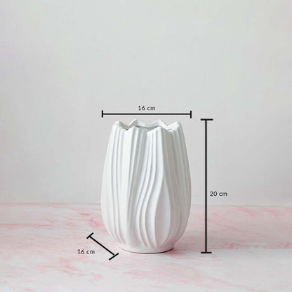 White textured vase with 20 cm height and 16 cm width displayed with measurements on a pink base.