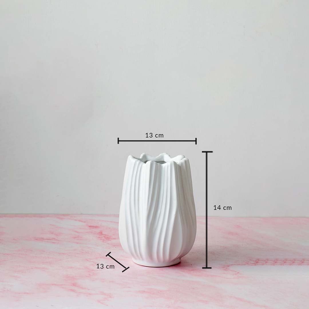 White-ceramic-vase with measurement dimensions 14 cm height and 13 cm width shown on pink marble surface for scale reference.