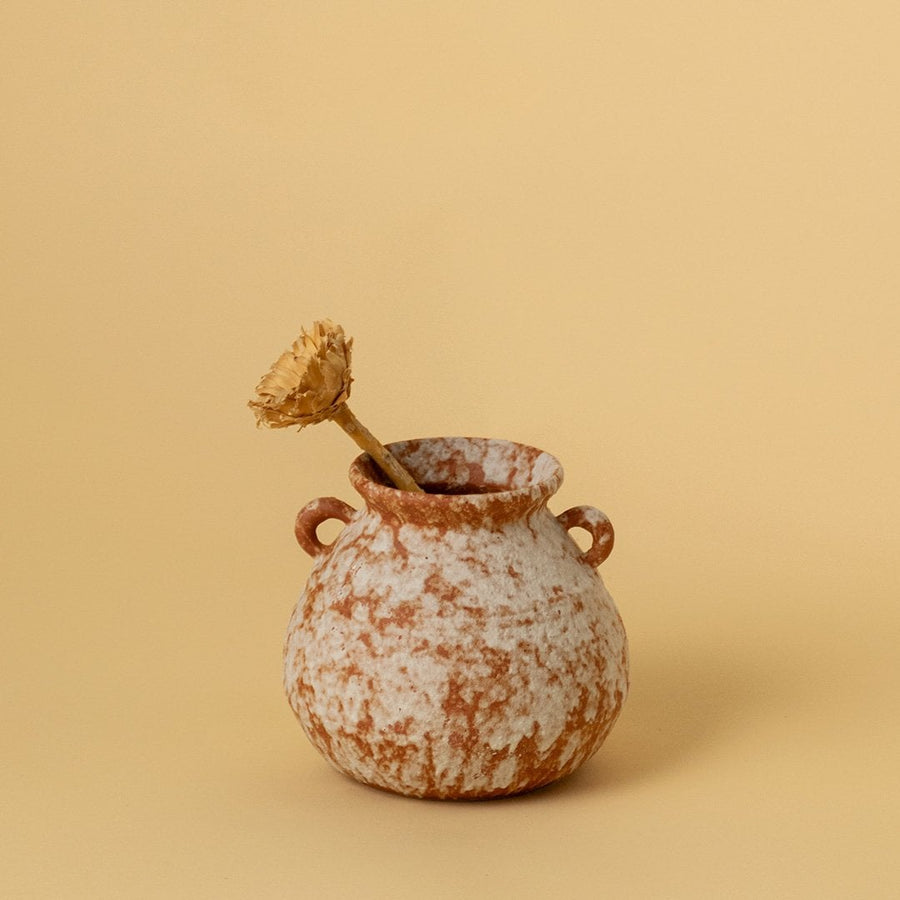 Rustic terracotta ceramic vases with handmade finish styled on table with greenery and artwork for modern interiors.