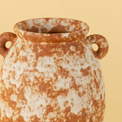 Rustic terracotta ceramic vase with handmade texture and side handles showing natural earthy orange white surface detail.
