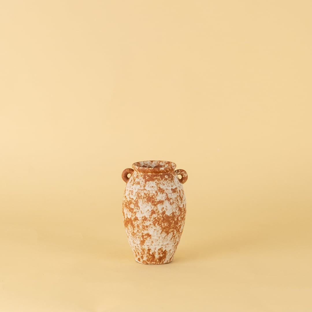 Handcrafted terracotta ceramic vase with dual handles in rustic orange white textured finish for modern home decoration.