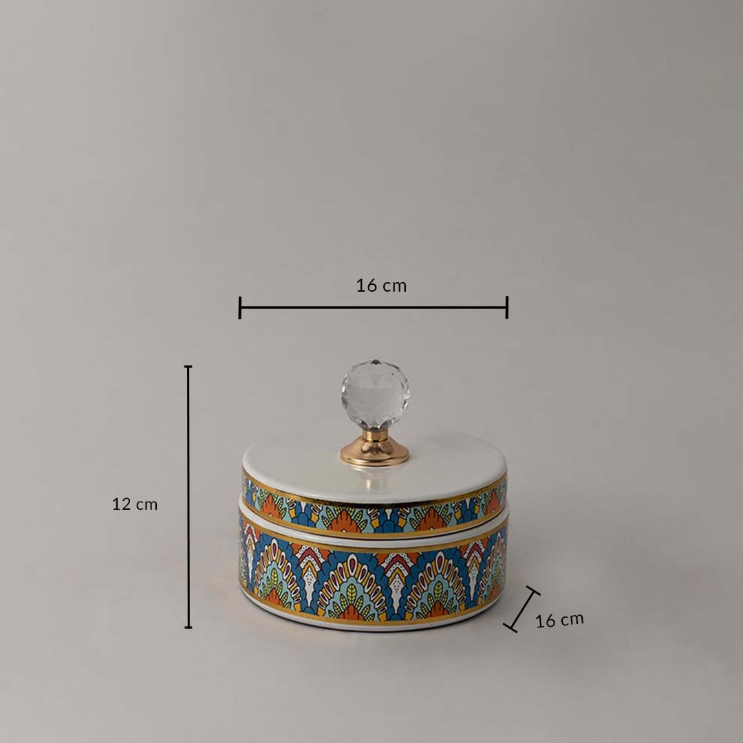 Decorative ceramic jar with artistic design and crystal knob shown with 12 cm height and 16 cm width dimension.