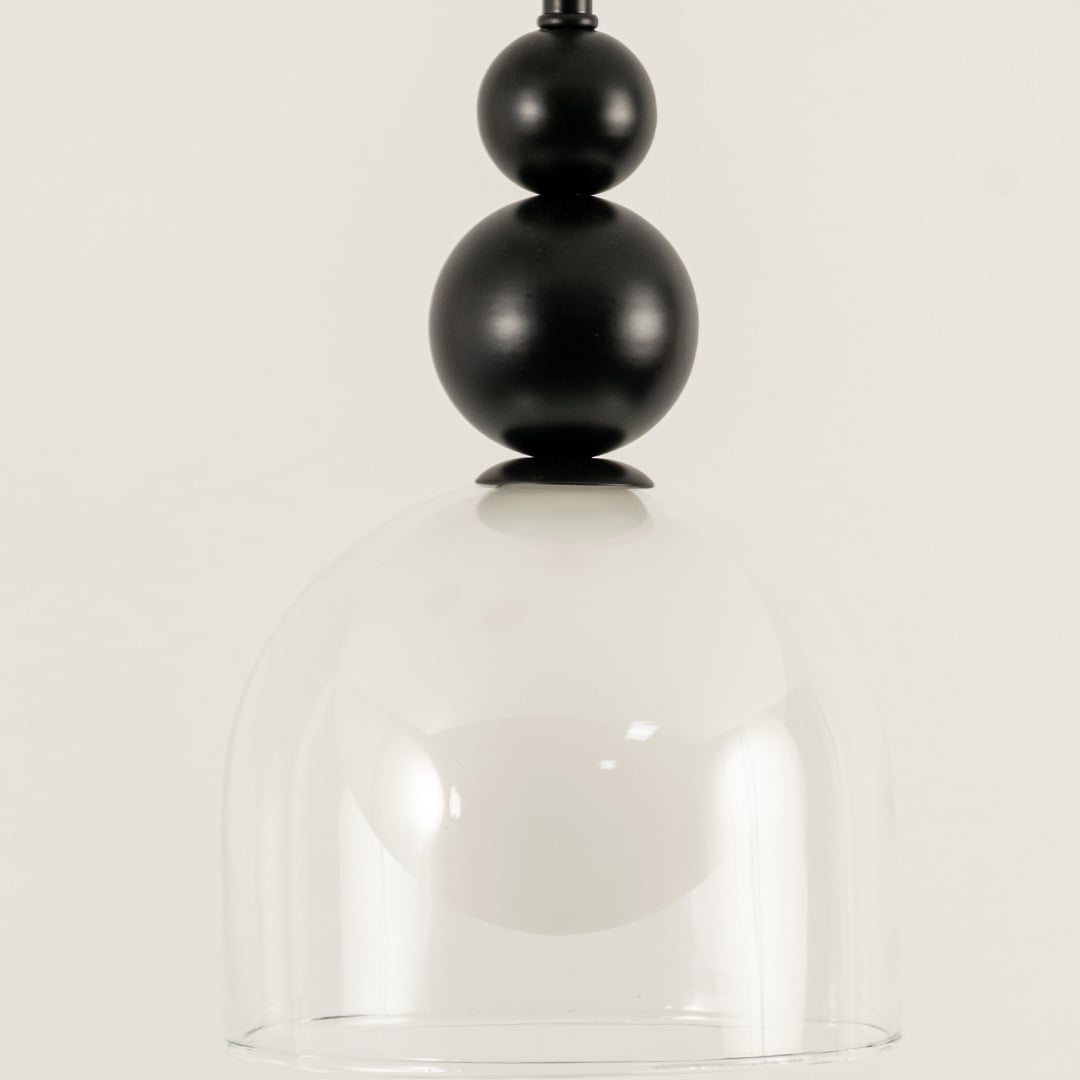 A modern pendant with black spheres white globe and clear glass shade ideal for LED chandelier lighting and clean minimal contemporary interior décor.