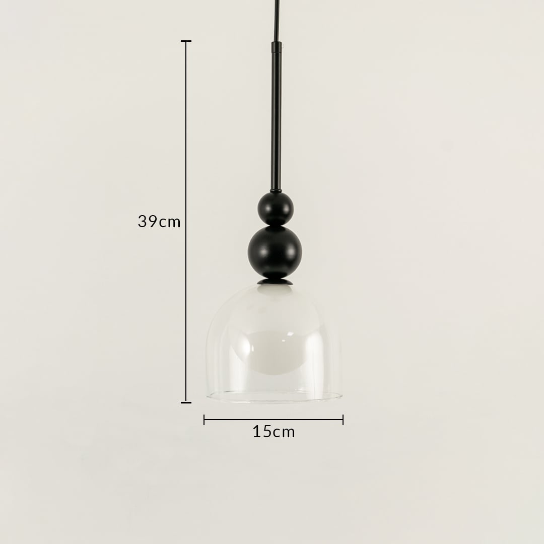 A pendant with black spheres and a clear glass shade measuring 39 cm height and 15.5 cm width set against a white background with the light off creating elegant contemporary décor.