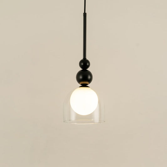 Black metal wall light with frosted glass globe illuminated to highlight sleek contemporary decorative lighting style.
