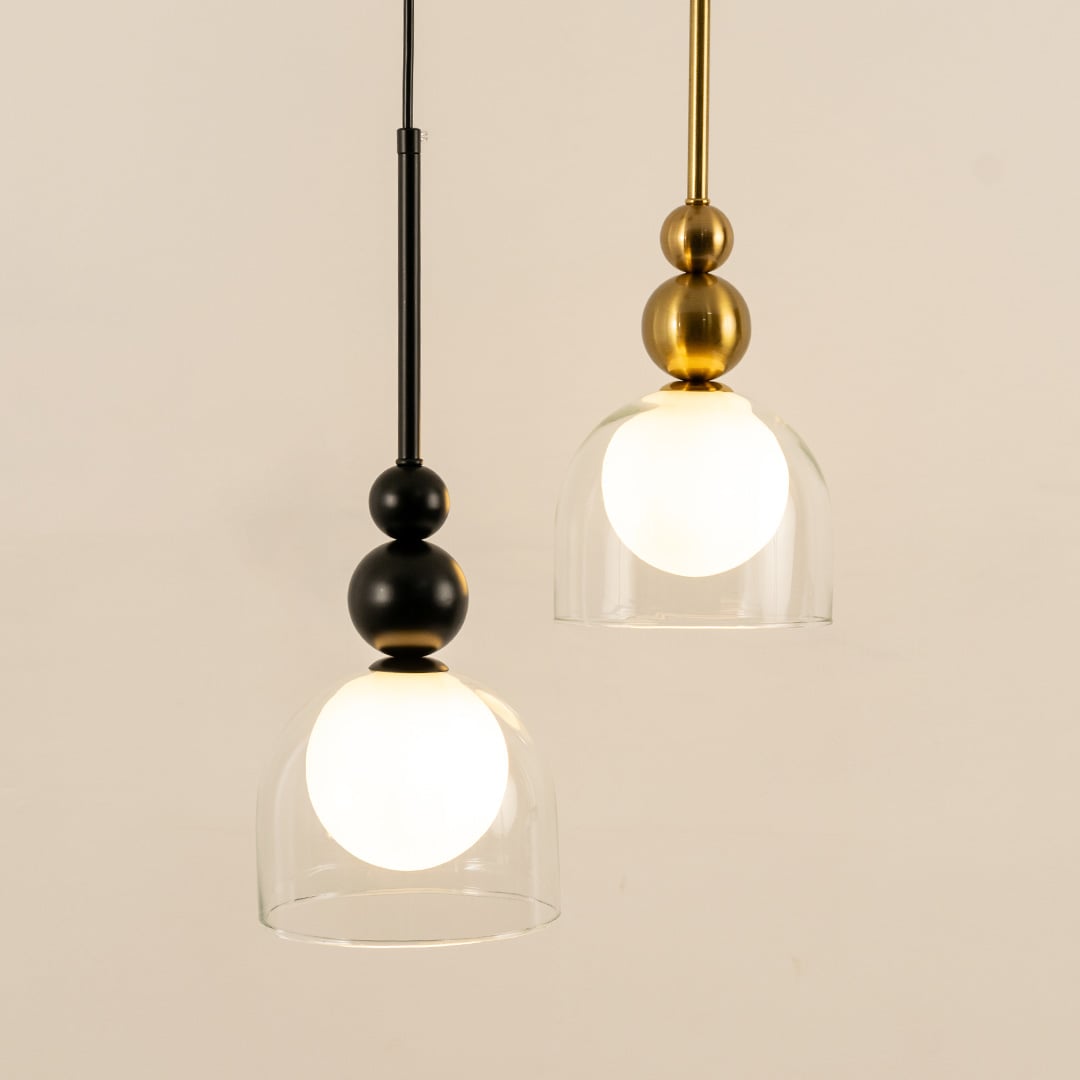 A refined pendant combination with black and gold fittings and white globes in clear shades ideal for modern LED décor and stylish interior lighting.