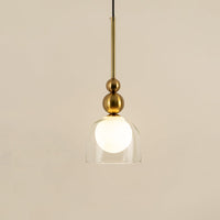 Gold metal pendant light with frosted glass globe illuminated to display luxury modern decorative ceiling lighting.