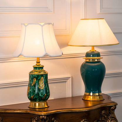 Table lamps with green ceramic bases and white shades placed on a carved wooden console adding elegance to a classic interior setting.