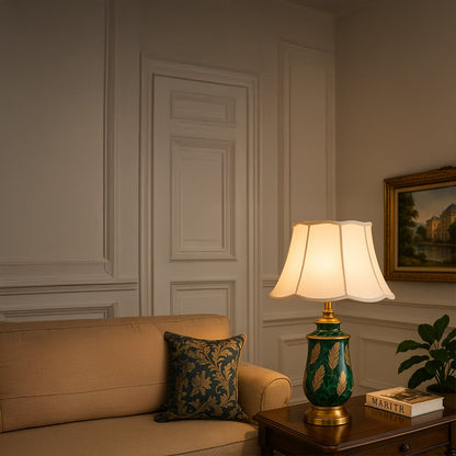 Ceramic green and gold base lamp with a white fabric shade creating a perfect balance of artistry and elegance for sophisticated decor.