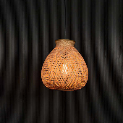 Natural rattan pendant light with handcrafted shade displayed on black background for rustic modern lighting.