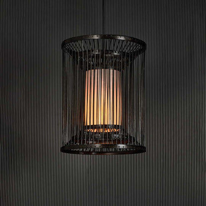 Black wire pendant light glowing warmly against black background revealing modern elegance and geometric charm.
