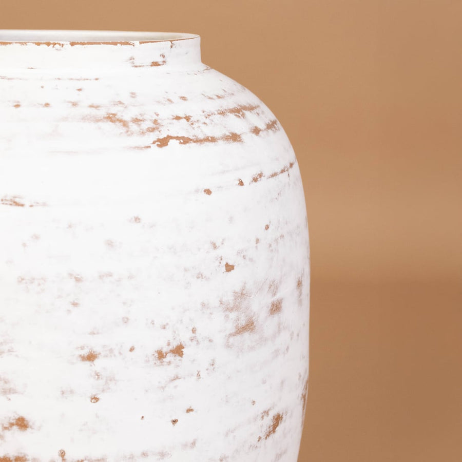 Closeup of white rustic textured decorative vase showing detailed weathered surface and sculpted shape ideal for artistic modern home decor.