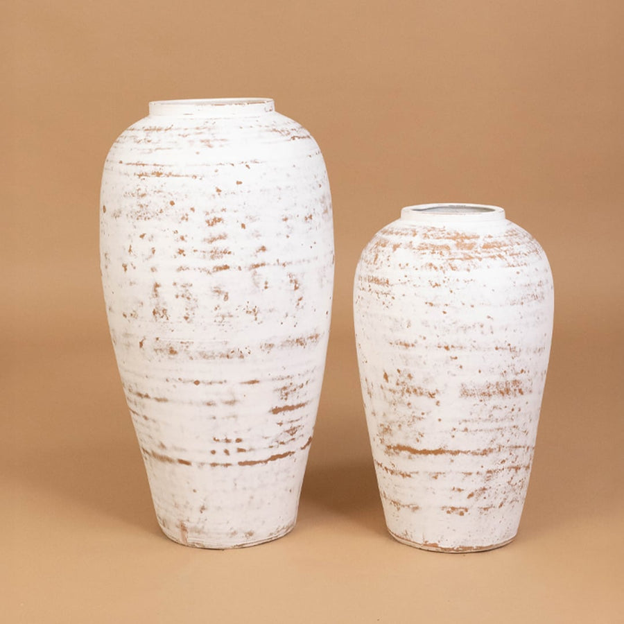 White rustic textured decorative vase displayed with coordinating decor pieces creating a stylish grouped arrangement for contemporary interiors.