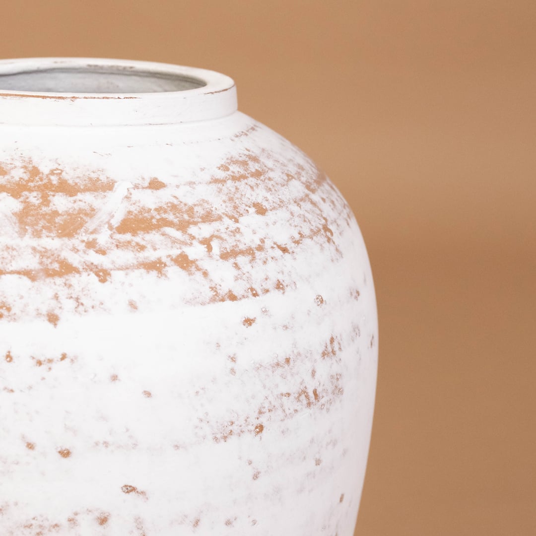Closeup of white rustic tall decorative vase showing detailed weathered texture and sculpted shape ideal for artistic modern home decor.