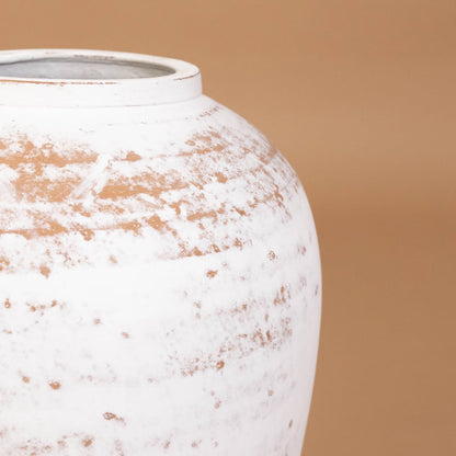 Closeup of white rustic tall decorative vase showing detailed weathered texture and sculpted shape ideal for artistic modern home decor.