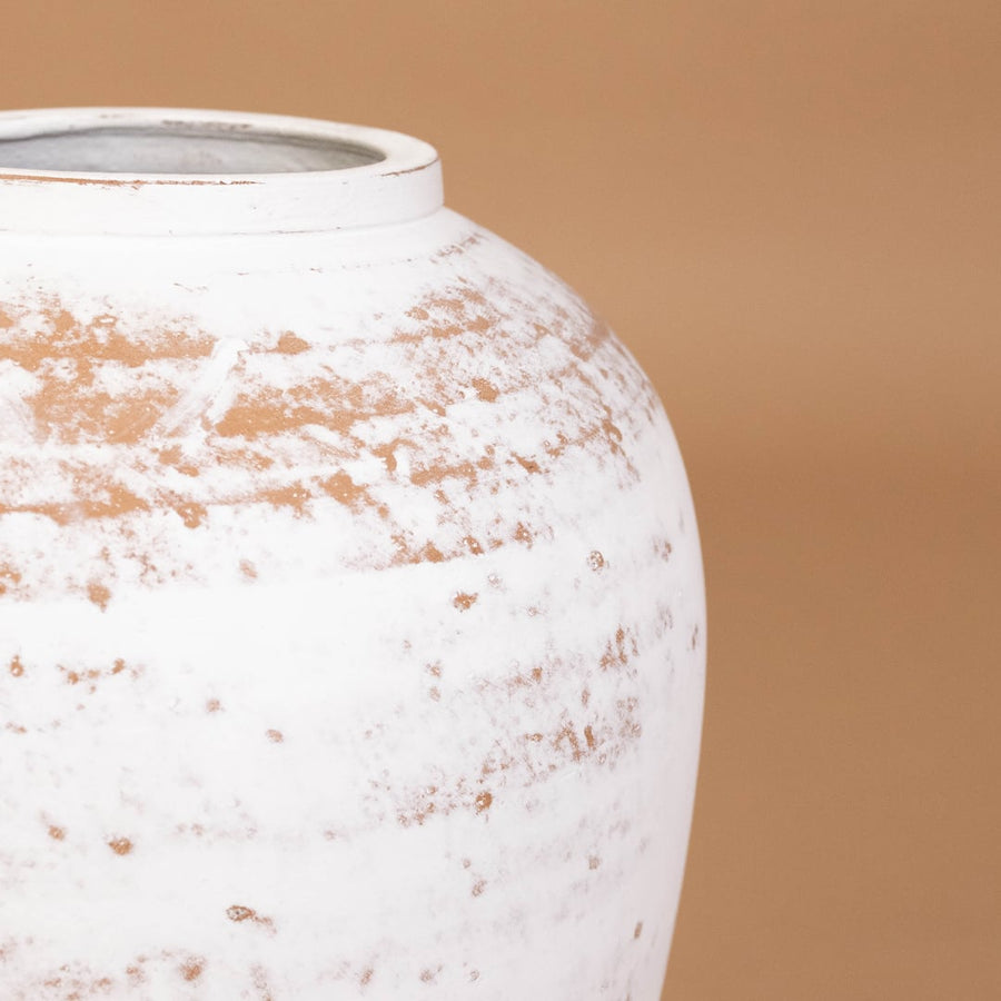 Closeup of white rustic tall decorative vase showing detailed weathered texture and sculpted shape ideal for artistic modern home decor.